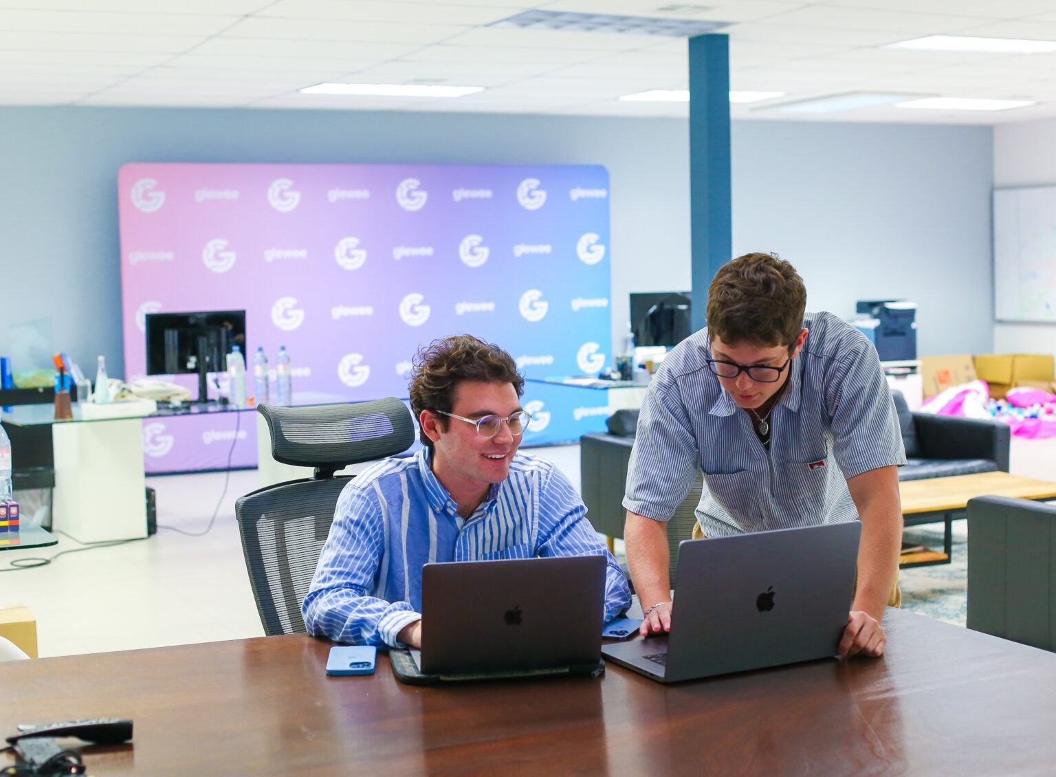 Christian Brown working with a teammate at the Glewee office